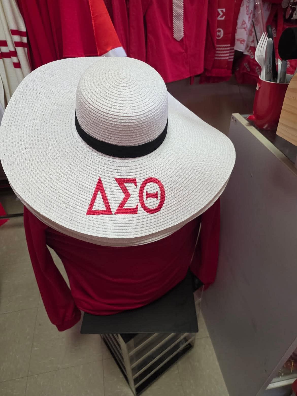 White wide-brim straw beach hat with red embroidered ΔΣΘ letters and a black band, displayed in the A & J Elite Greek Store