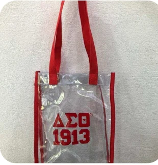 Clear long-drop stadium tote with red trim and DST 1913 lettering