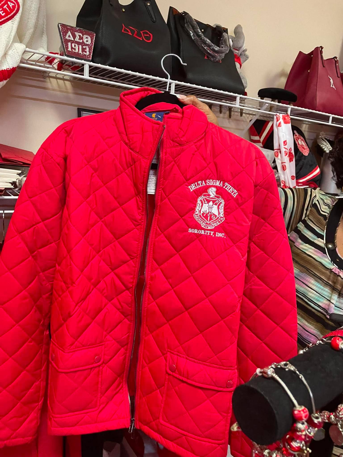 Red diamond-quilted jacket with embroidered Delta Sigma Theta Sorority, Inc. crest