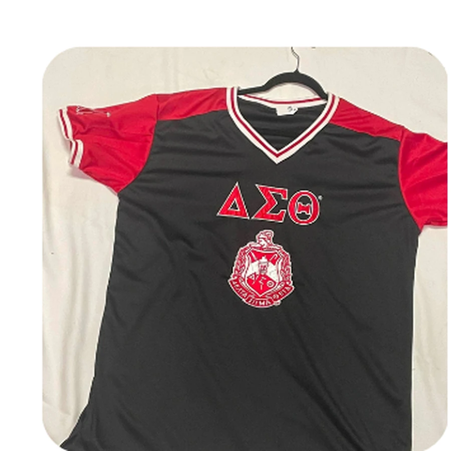 Black athletic jersey with red sleeves, DST letters and crest